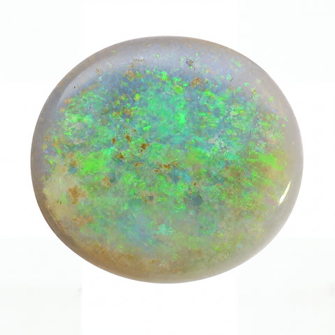 Close-up of a green and brown opal stone on a white background