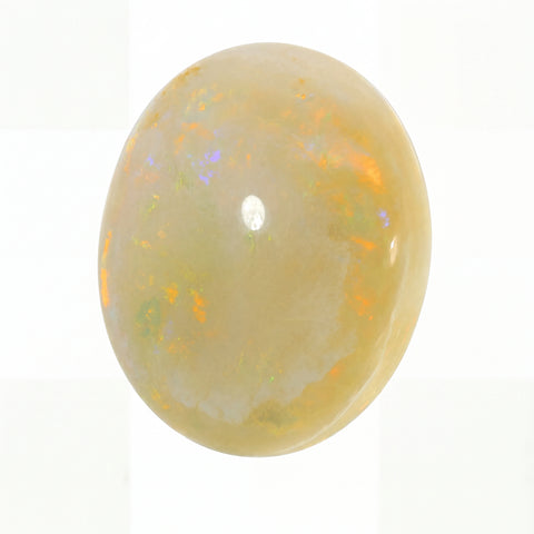 Opal stone with colourful play of light on a white background