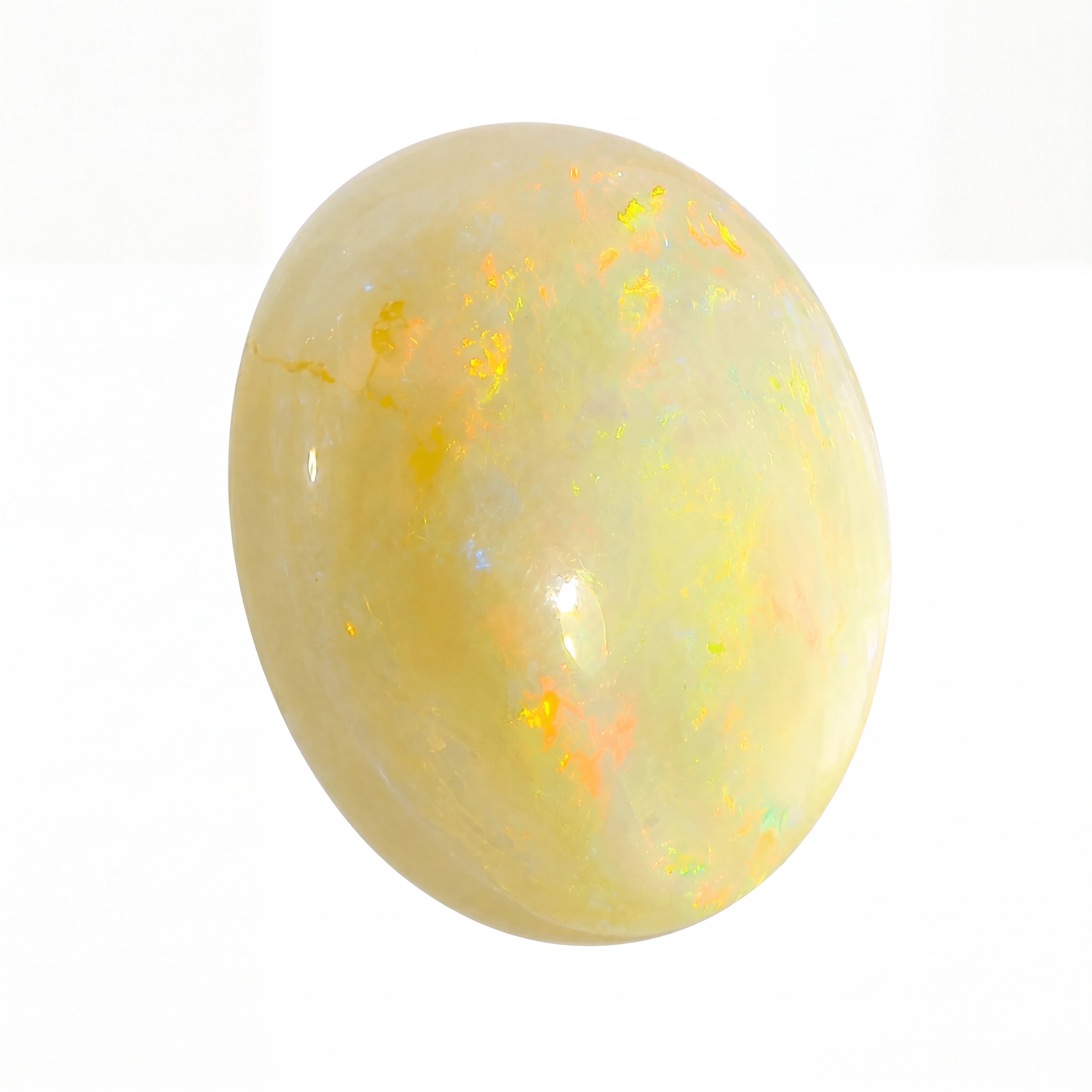 Opal stone with a yellowish hue on a white background
