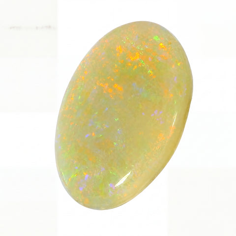 Opal stone with multicoloured play of light on a white background