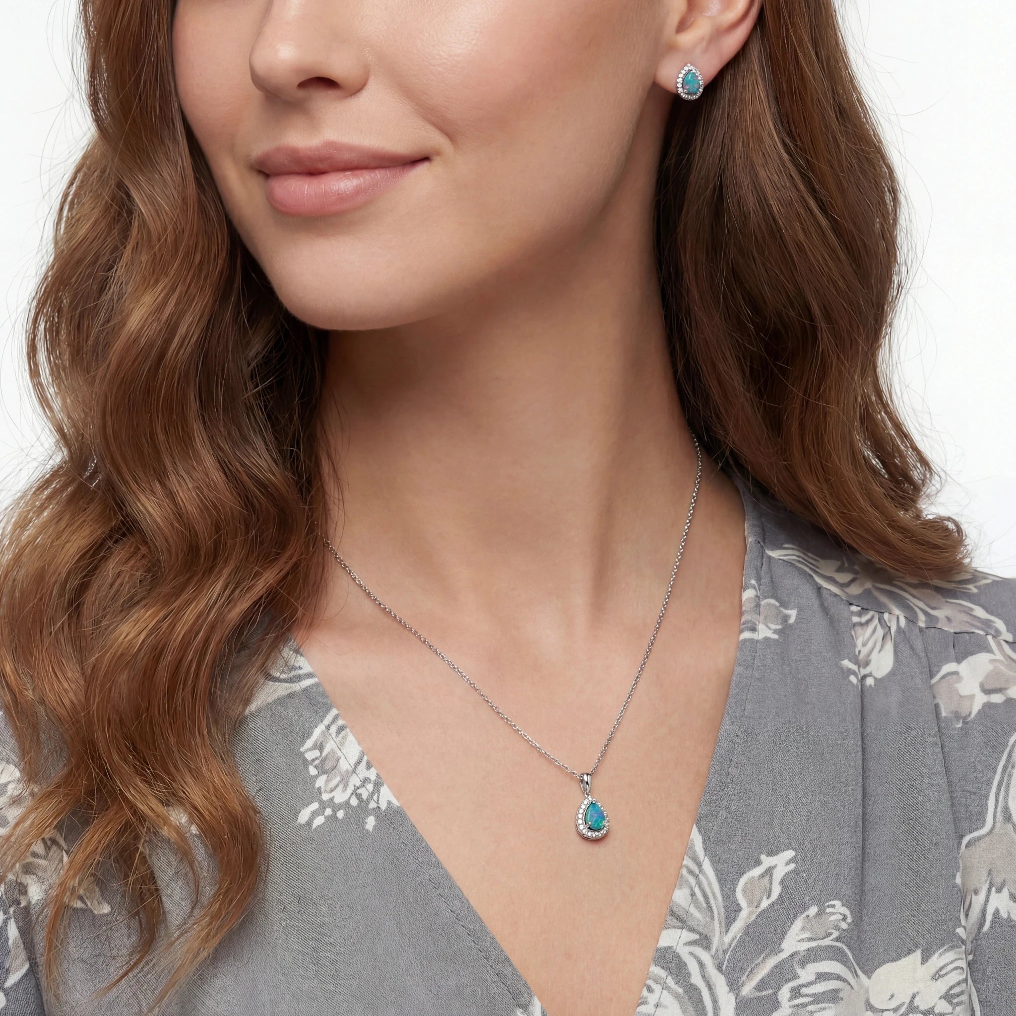 Woman wearing a necklace with a blue pendant on a white background