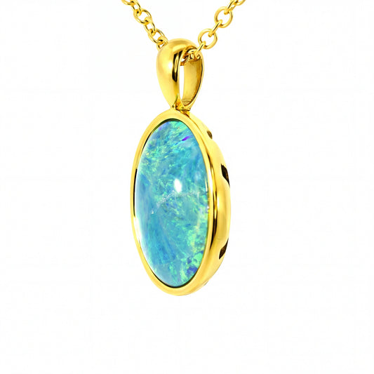Gold pendant with a blue opal stone on a white background