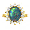Gold ring with an opal stone and diamonds on a white background