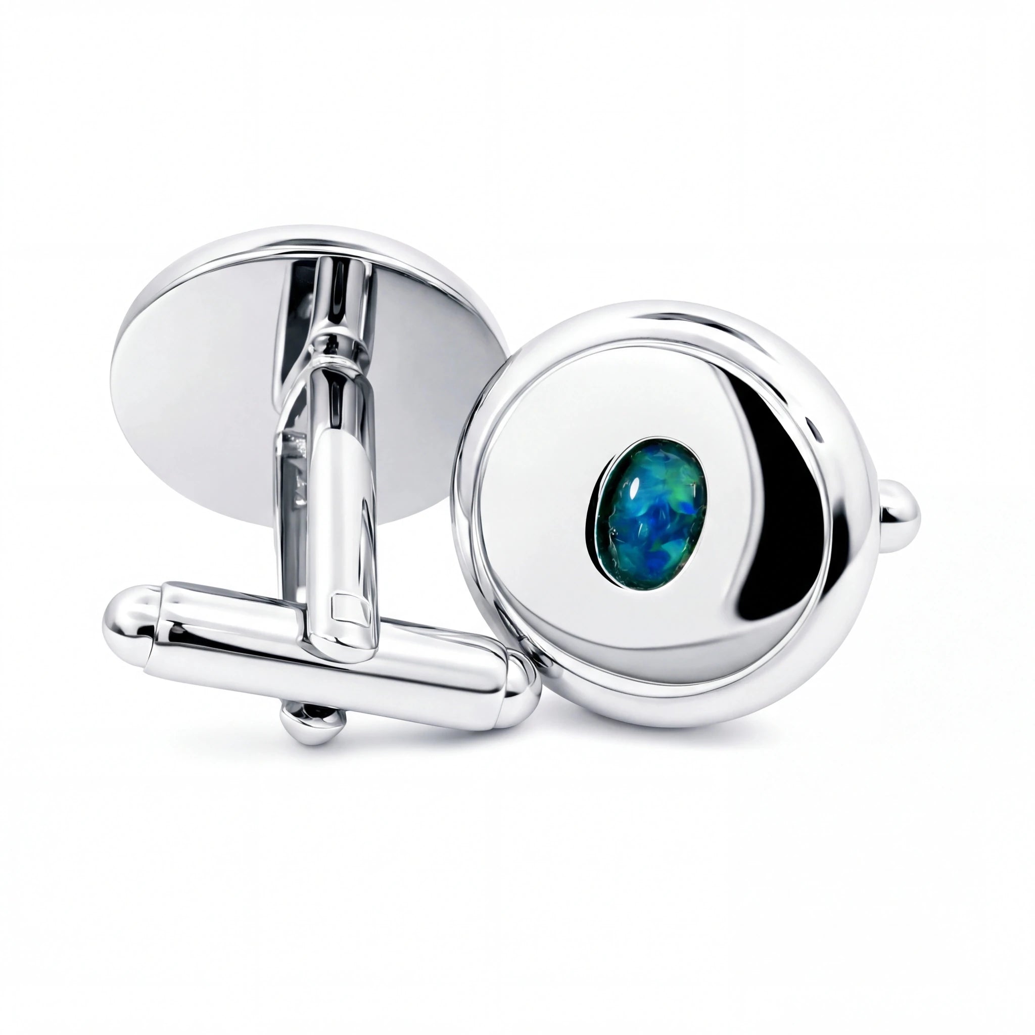 Silver cufflinks with a central green gemstone on a white background