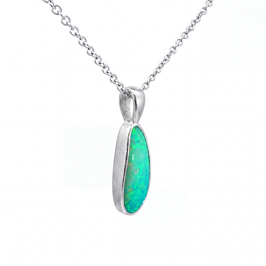 A silver chain necklace with a teardrop-shaped pendant featuring a vibrant green opal gemstone in a polished silver bezel setting, shown against a plain white background.