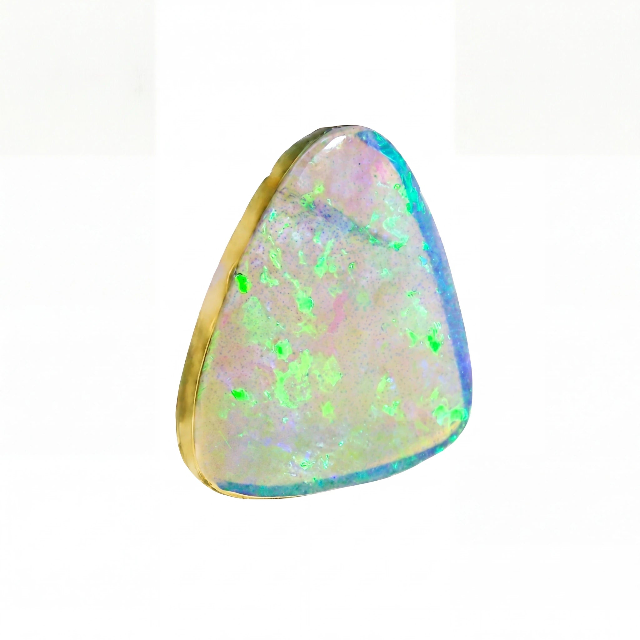 A triangular cabochon opal gemstone with a gold bezel setting, showcasing a play-of-colour pattern with vibrant green, blue, pink, and white flashes on a white background.