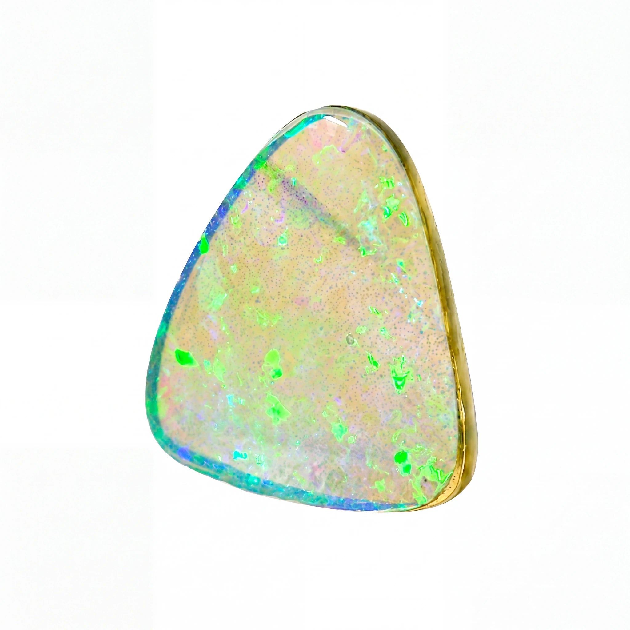 A triangular bezel-set opal gemstone with a gold-toned metal border, showcasing a play-of-colour pattern with vibrant green, blue, and pink flashes on a pale cream background, isolated on a white background.