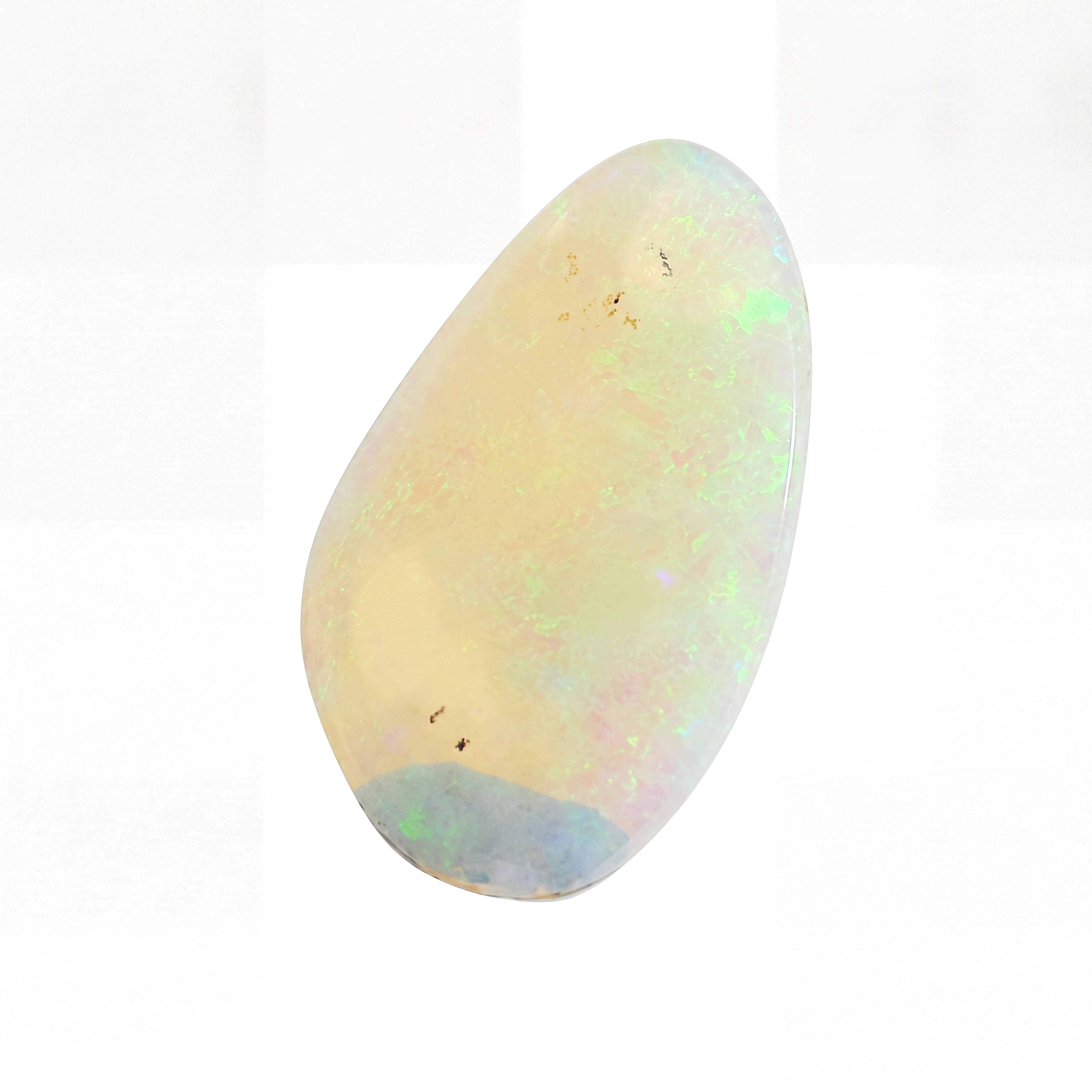 A polished teardrop-shaped cabochon opal gemstone with a creamy off-white base and vibrant iridescent flashes of green, blue, and pink, set against a plain white background.