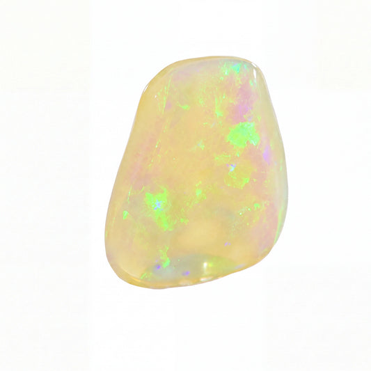 A polished, irregular-shaped opal gemstone displaying a creamy yellow base colour with vibrant, shifting flashes of green, purple, and blue, set against a plain white background.