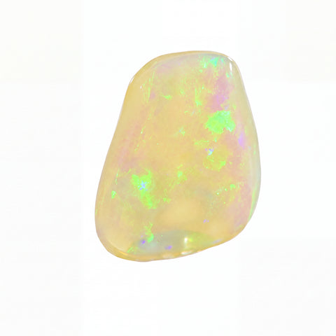 A polished, irregular-shaped white opal gemstone with vibrant green, purple, and yellow flashes, shown on a solid white background.