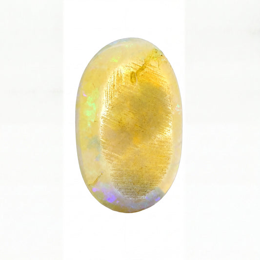 A polished oval cabochon gemstone with a dominant golden-yellow hue and subtle iridescent flashes of green, blue, and purple, set against a plain white background.