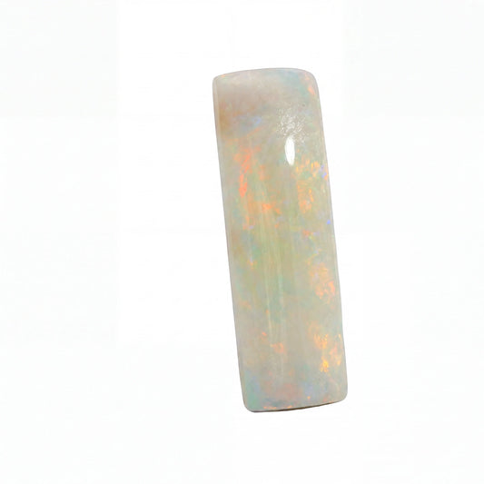 A polished rectangular cabochon gemstone with a white base and iridescent flashes of orange, blue, and green, shown on a plain white background.