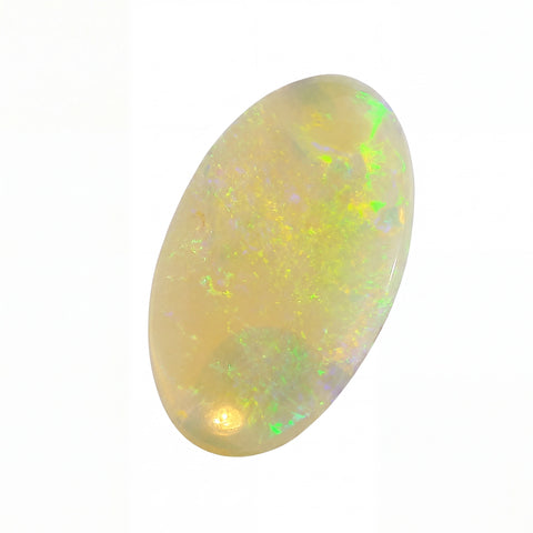 A polished oval cabochon opal gemstone displaying a creamy yellow base with vibrant flashes of green, blue, and orange, set against a plain white background.