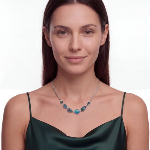 Woman wearing a necklace with blue stones on a white background