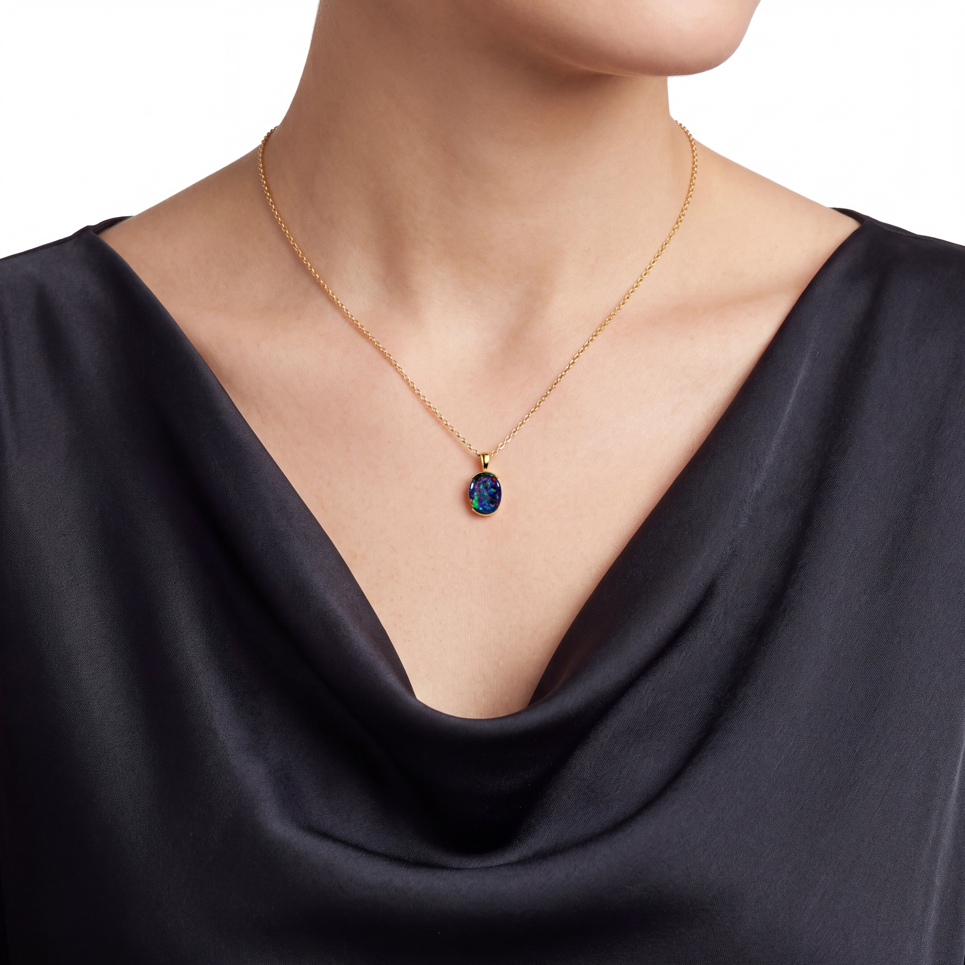 Woman wearing a gold necklace with a pendant on a white background