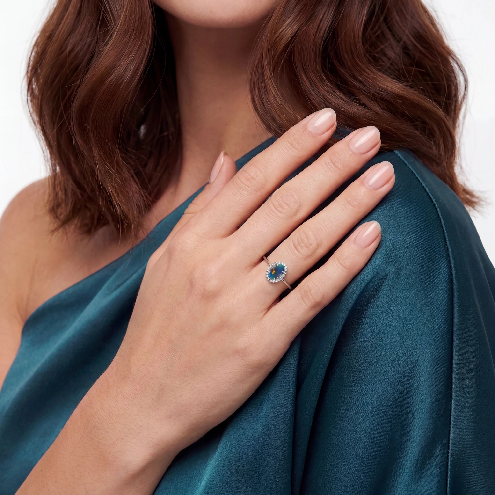 Woman wearing a blue gemstone ring on a white background