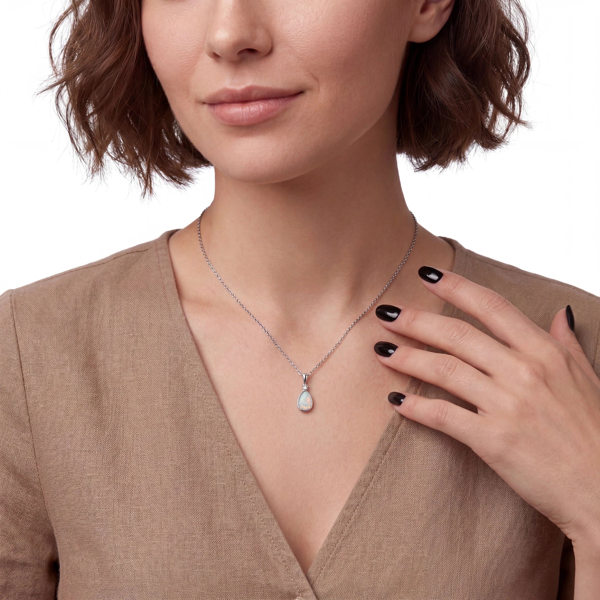 Woman wearing a necklace with an opal pendant