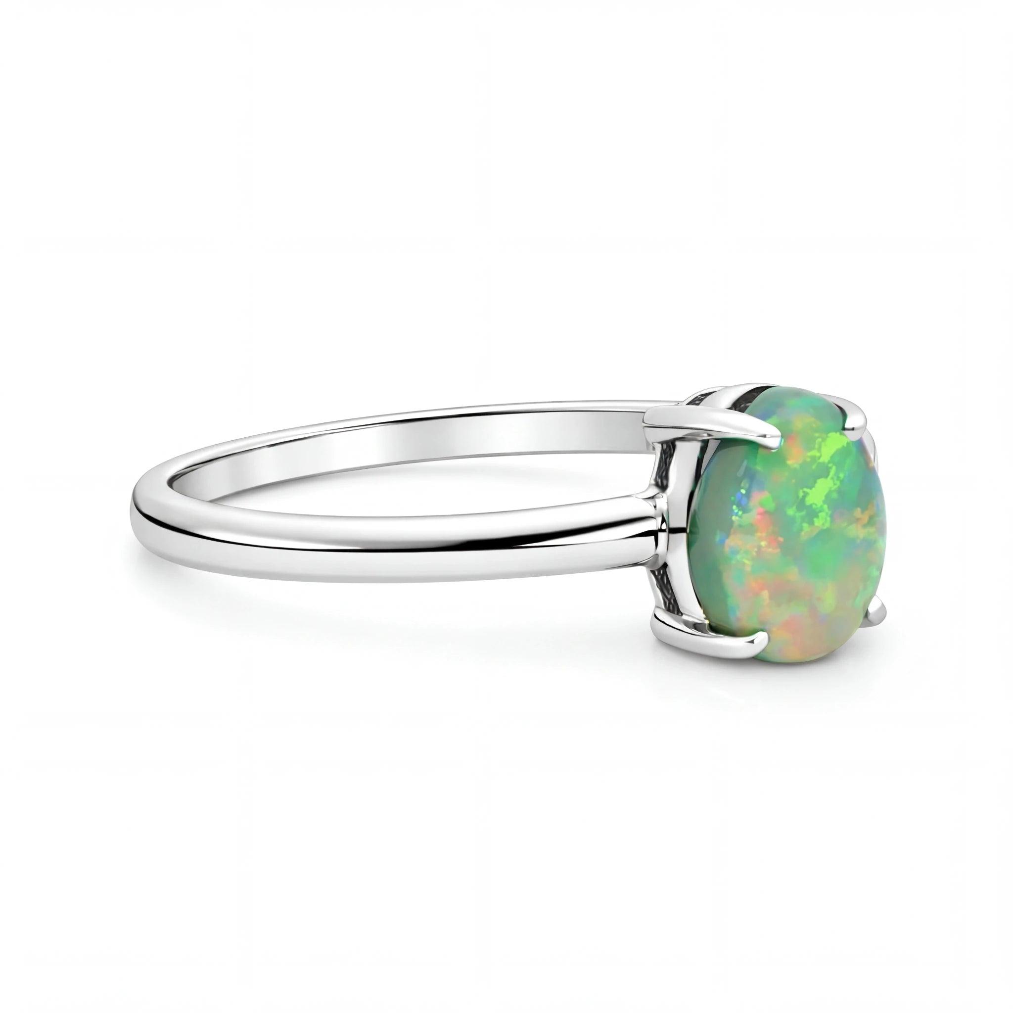 Silver ring with a green opal stone on a white background
