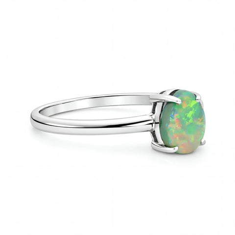 Silver ring with a green opal stone on a white background