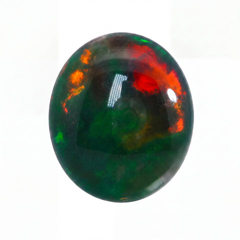 Opal stone with green, red, and orange colours on a white background