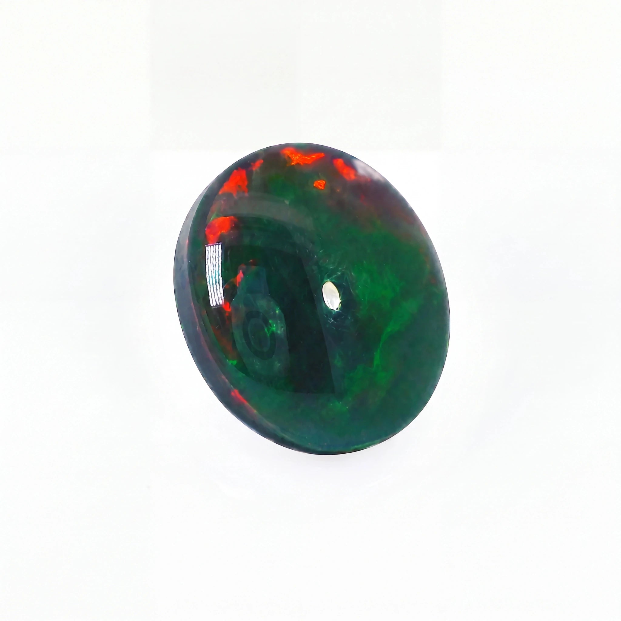Green and red opal stone on a white background