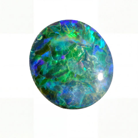 Round opal stone with green and blue colours on a white background