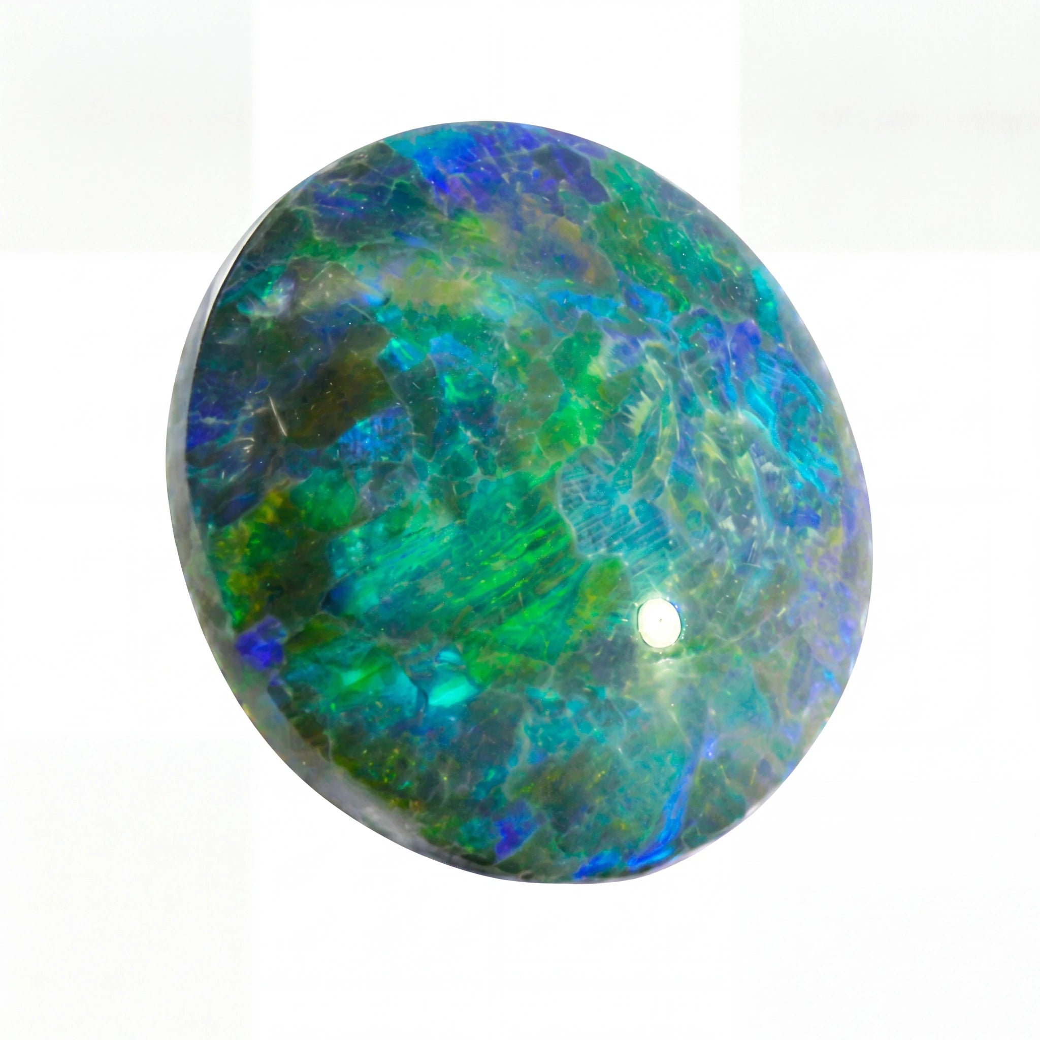 Round opal stone with multicoloured patterns on a white background