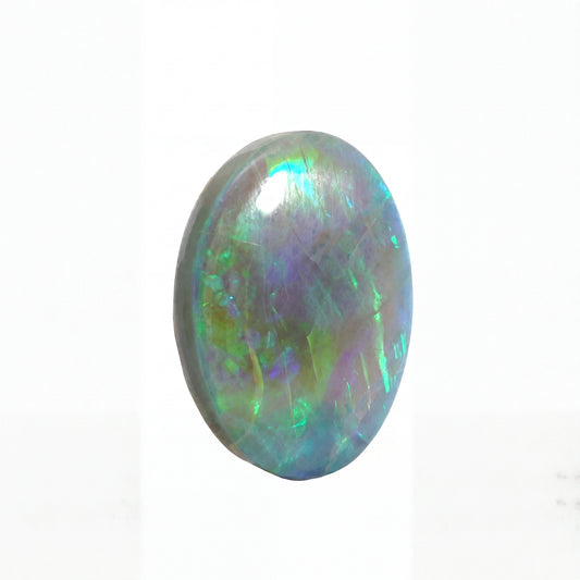 Multicoloured opal stone on a white background