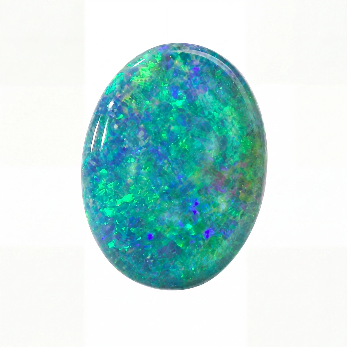 A polished oval cabochon gemstone featuring a vibrant play-of-colour pattern with green, blue, and purple flashes on a white background.