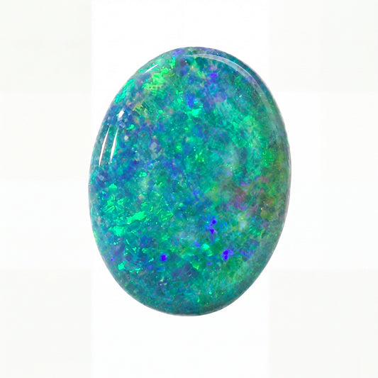 Oval-shaped opal stone with vibrant green and blue colours on a white background