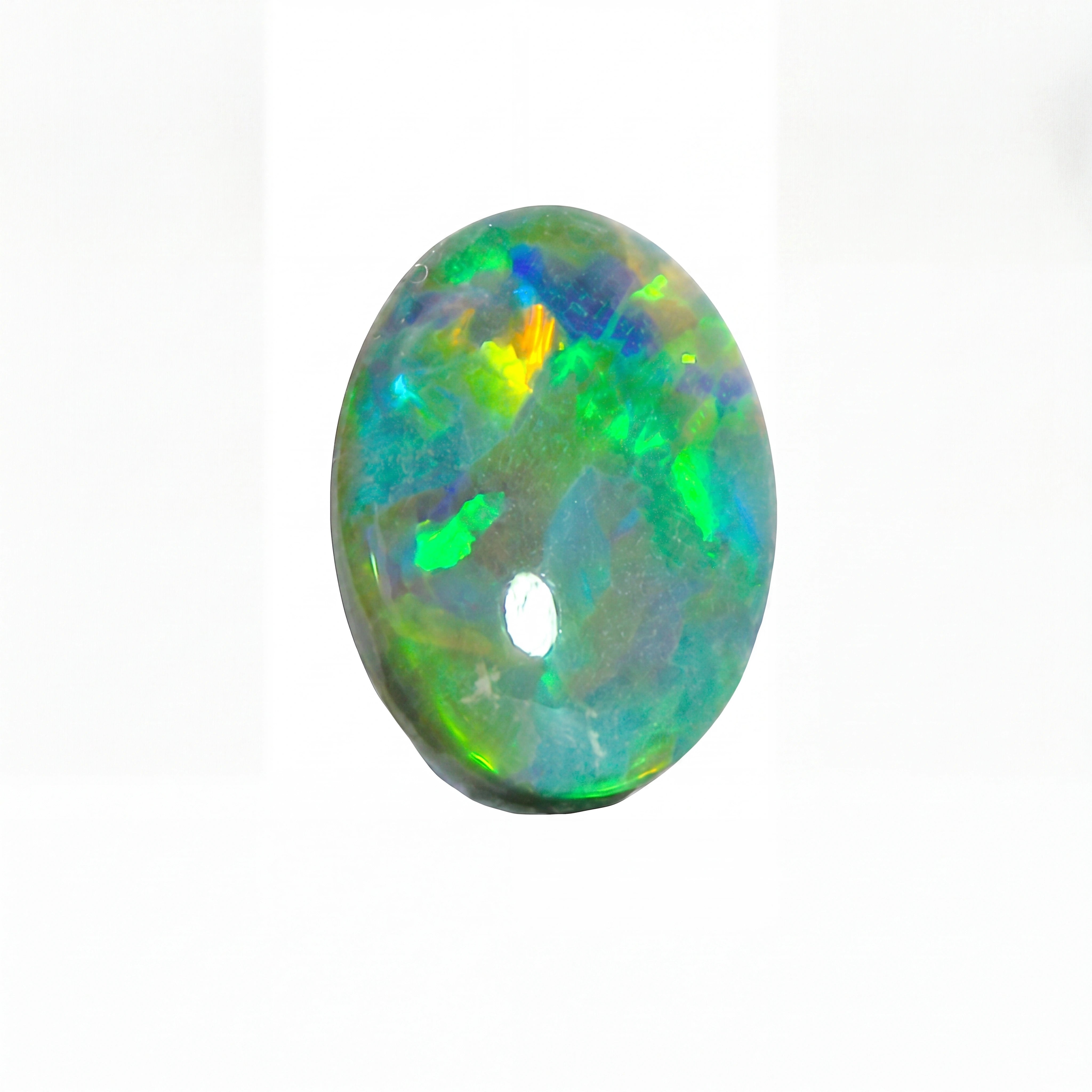 Oval-shaped opal gemstone with multicolour play on a white background