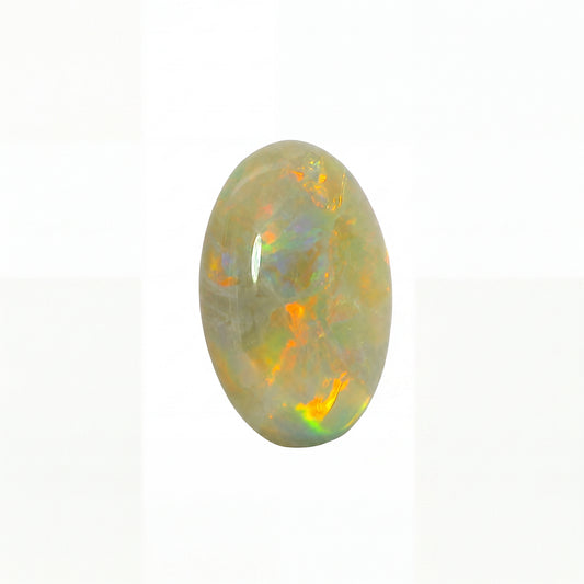 Opal stone with colourful play of light on a white background