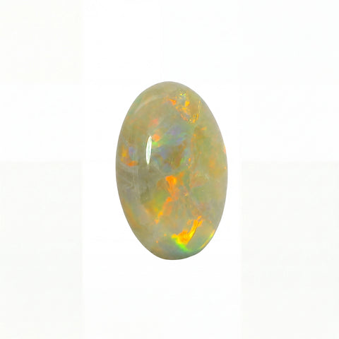 A polished oval cabochon opal gemstone displaying a play-of-colour with vibrant orange, yellow, and green flashes against a pale grey-white background.