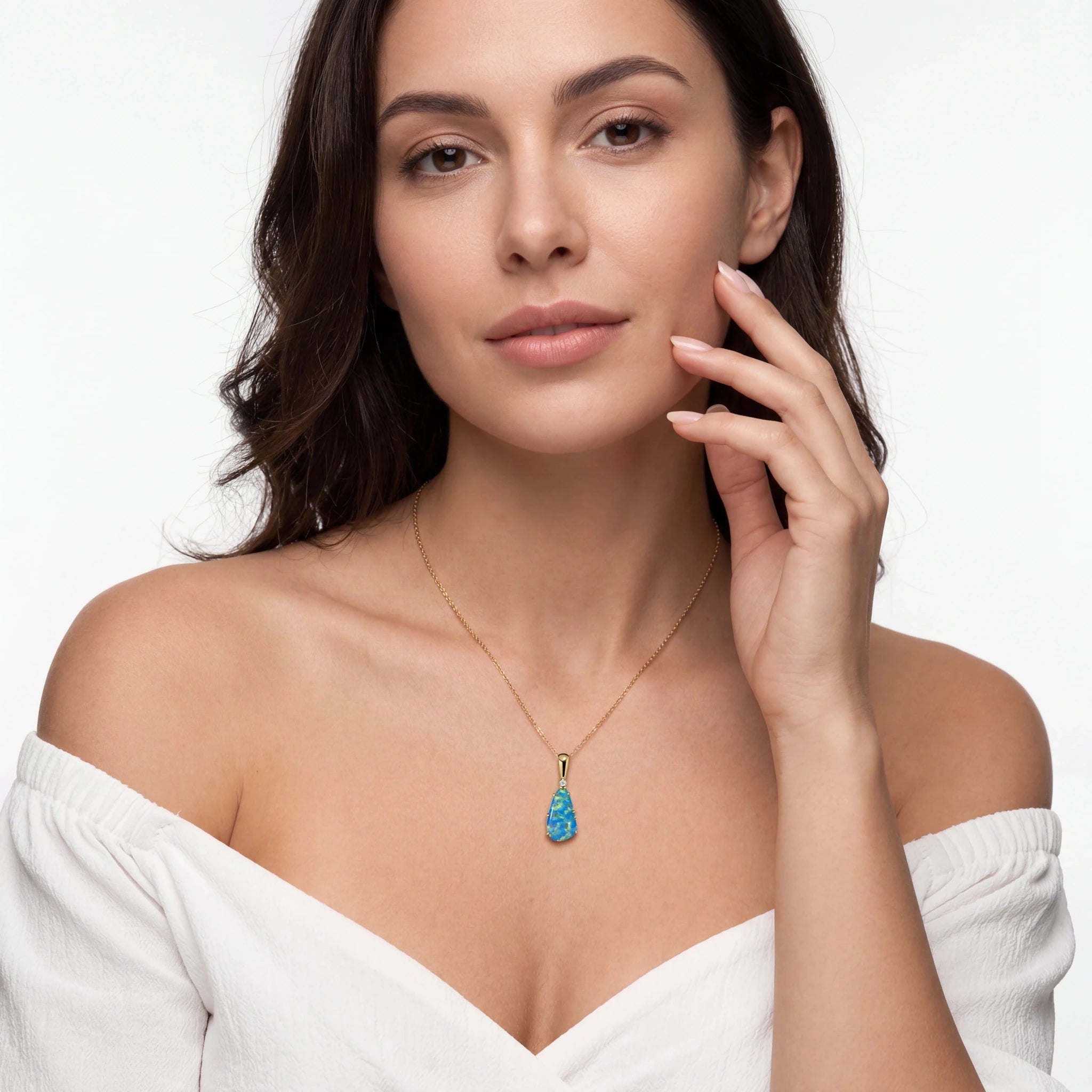 Woman wearing a necklace with a blue opal pendant on a white background