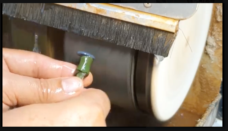 Close-up of opal being polished during the Opal Cutting Experience
