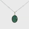 Video of a Silver pendant with a green stone on a white background
