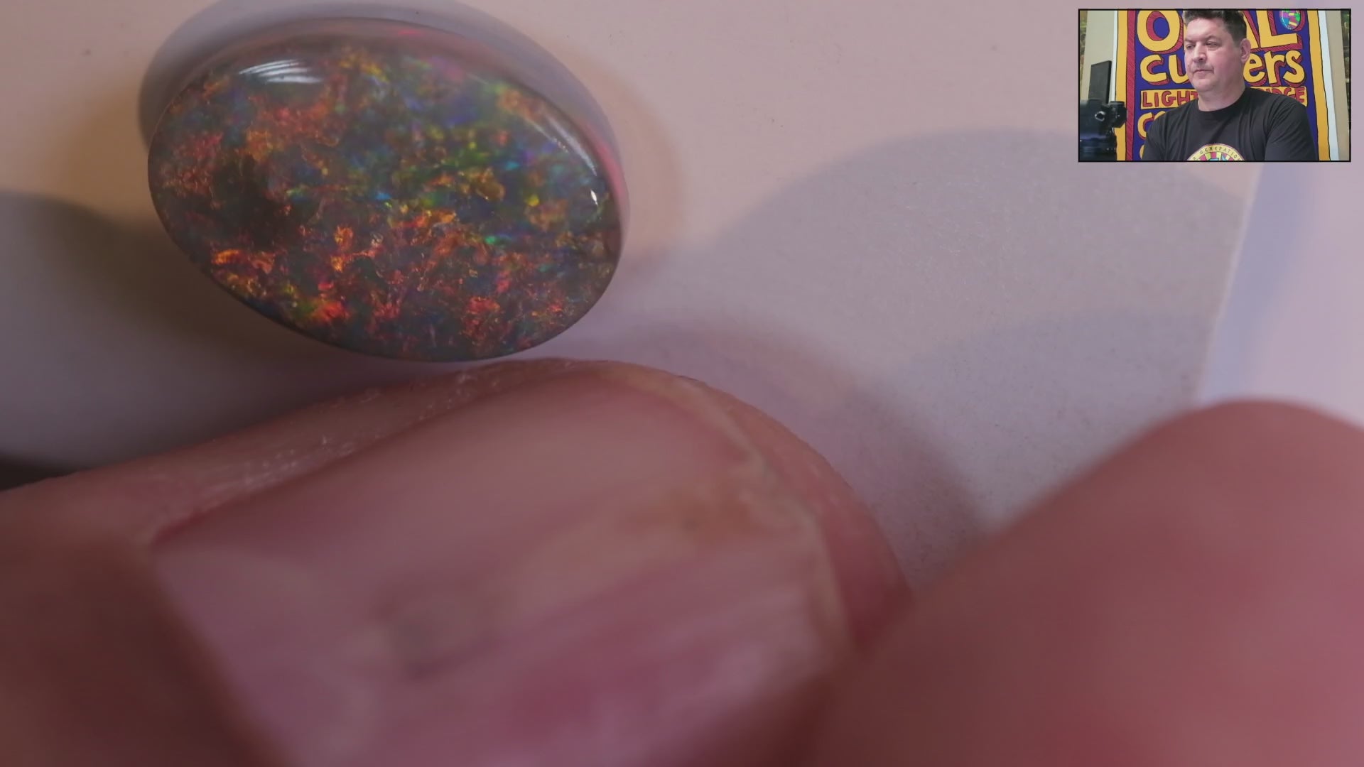 Video of a Multicoloured opal stone on a white background