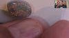 Video of a Multicoloured opal stone on a white background