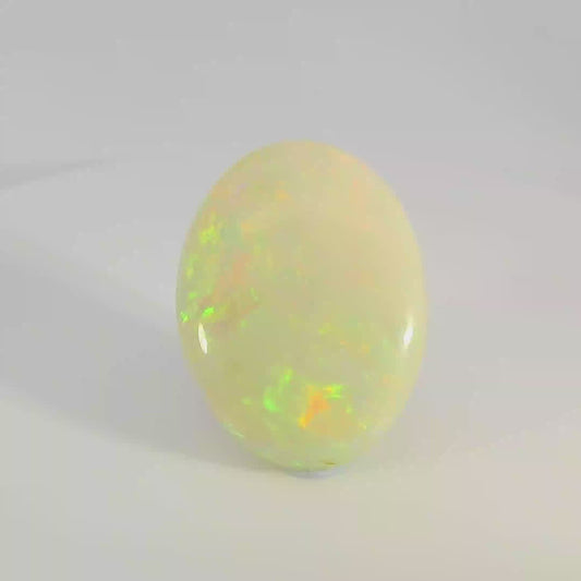 Opal stone with multicoloured play of light on a white background