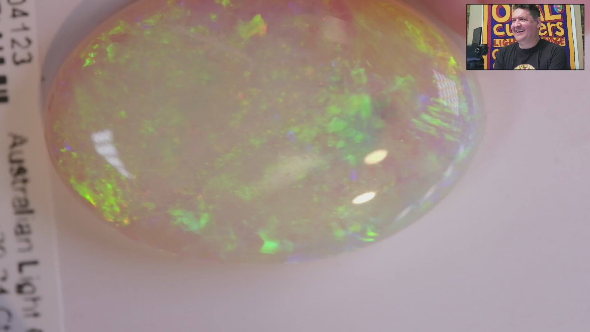 Video of an Oval-shaped opal stone with green and yellow colours