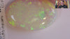 Video of an Oval-shaped opal stone with green and yellow colours