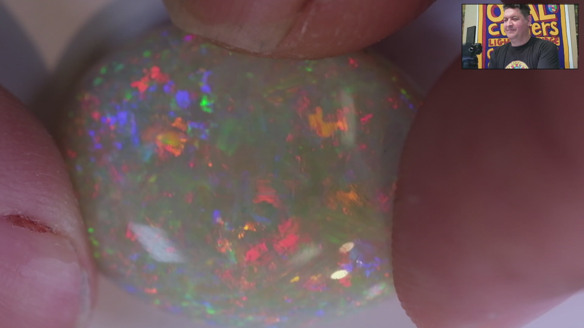 Video of a Multicoloured opal stone on a white background