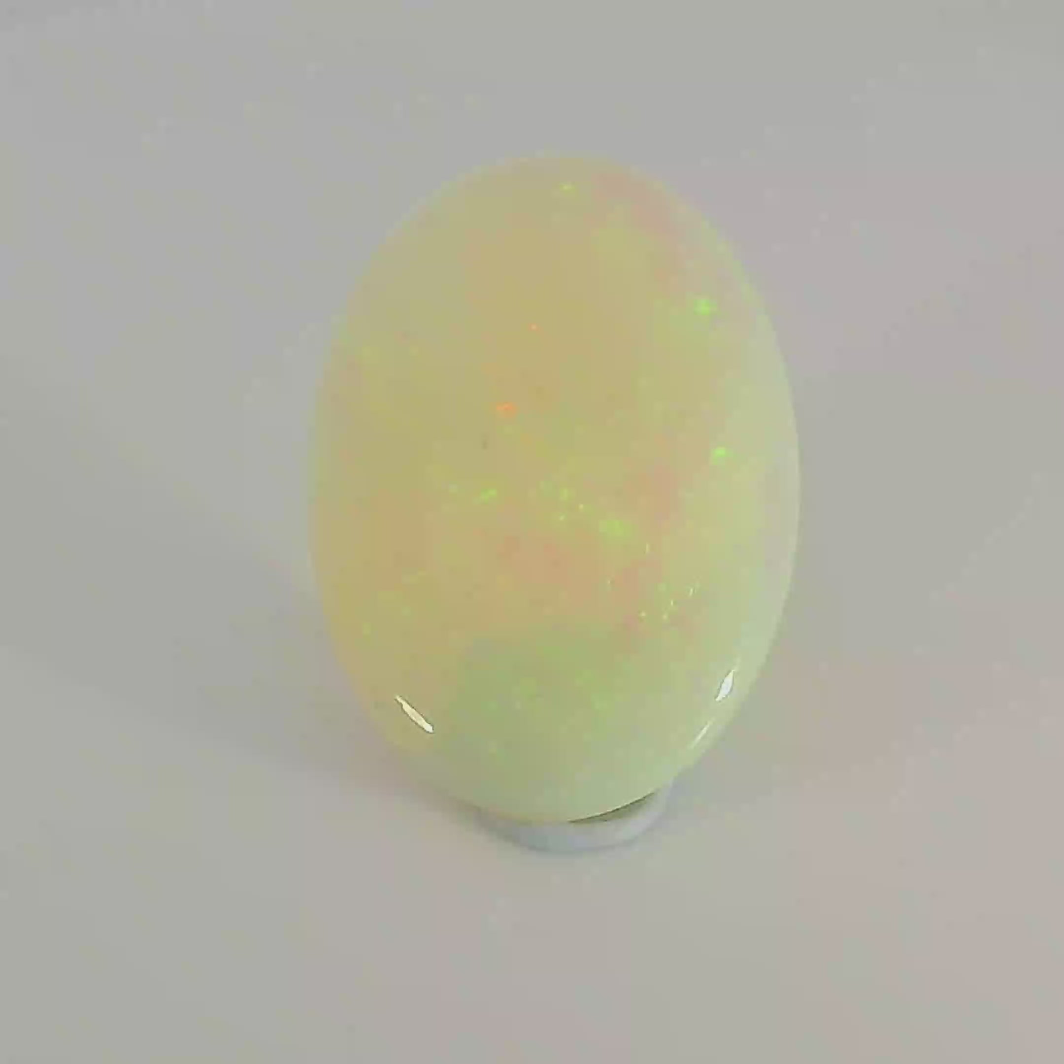 Glistening Opal Gemstone in Hand