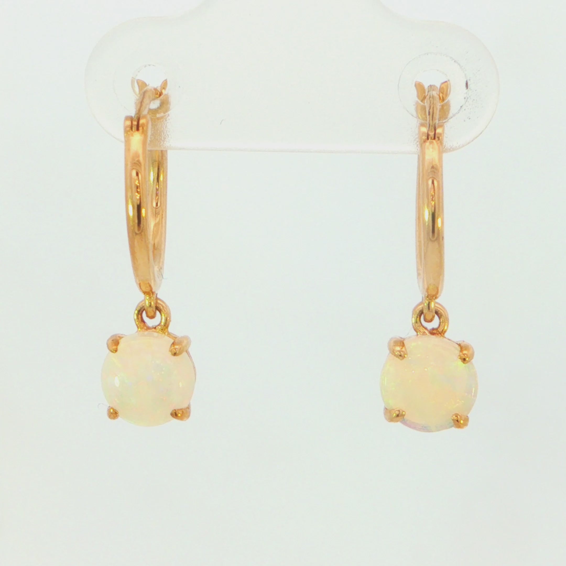 Video of a pair of gold hoop drop earrings with round iridescent opal gemstones