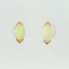 Video of a pair of gold stud earrings featuring marquise-cut white opal gemstones in a prong setting