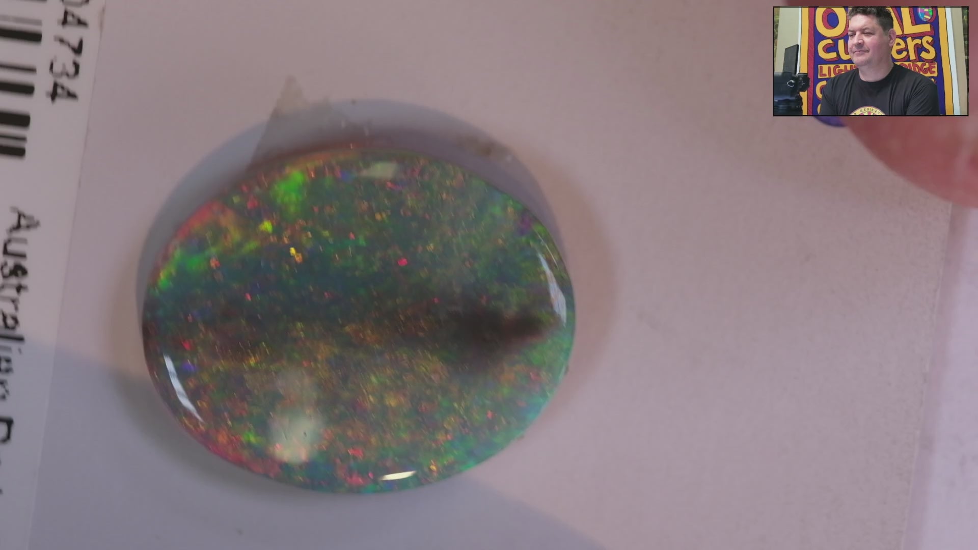Video of a Multicoloured opal stone on a white background