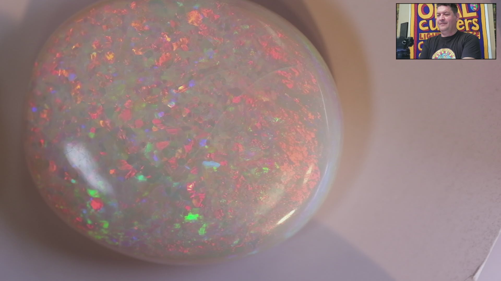 Video of a Multicoloured opal stone on a white background