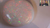 Video of a Multicoloured opal stone on a white background