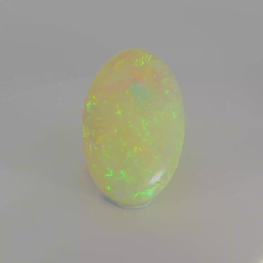 Video of an Oval-shaped opal stone with green and yellow colours
