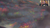Video of an Opal stone with multicoloured fluorescence on a white background